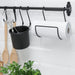 IKEA HULTARP black rail mounted on kitchen wall with utensils and paper towel holder attached