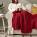 Stylish dark red throw, sized 170x130 cm for comfortable lounging.