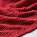 Close-up of the soft, textured knit of the dark red IKEA HUMLEMOTT throw