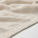 Close-up of the soft, textured knit of the IKEA HUMLEMOTT throw