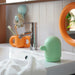 IKEA HUMLESJÖN soap dispenser light green styled in a children's bathroom with toothbrush holder
