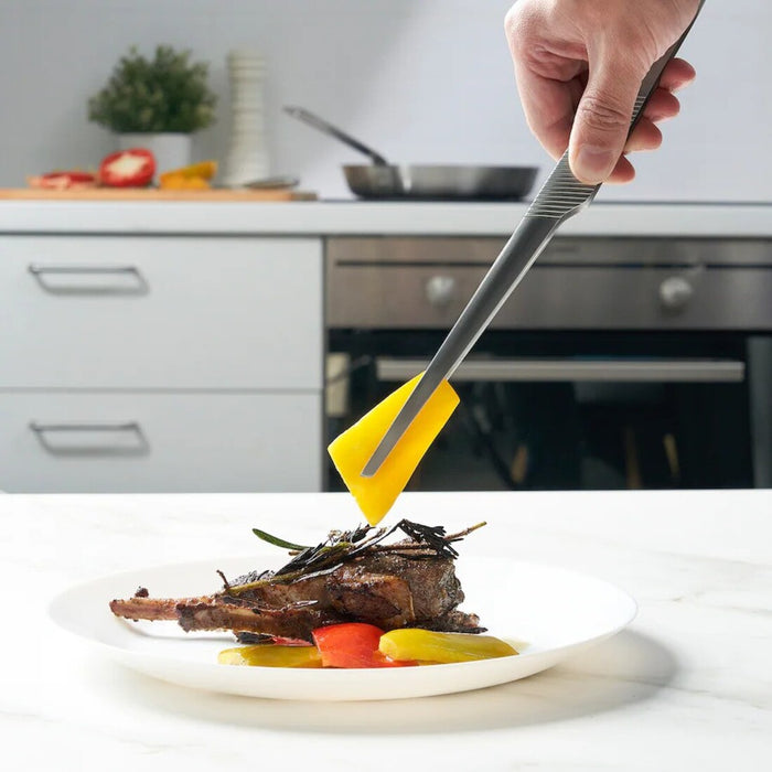 "Serving herbs with IKEA IDEALISK Cooking Tweezers at a dinner table.