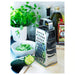 IKEA IDEALISK grater with grated cucumber, bowl and herbs on white kitchen counter