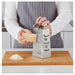 IKEA IDEALISK stainless steel grater in use grating cheese on wooden cutting board