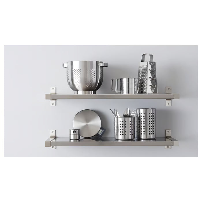 IKEA IDEALISK grater stored on stainless steel kitchen shelf with other cooking utensils