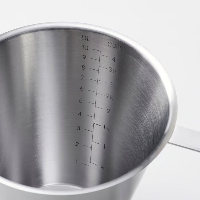 Close-up of IKEA IDEALISK stainless steel jug showing engraved graduation markings up to 1 litre