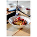 IKEA 365+ white bowl filled with raspberries and crumble on wooden dining table