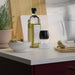 IKEA 365+ white bowl on kitchen counter beside oil bottle salt shaker and chopped onion