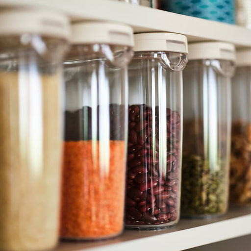IKEA 365+ clear jars with white flip lids storing beans and pulses on kitchen shelf