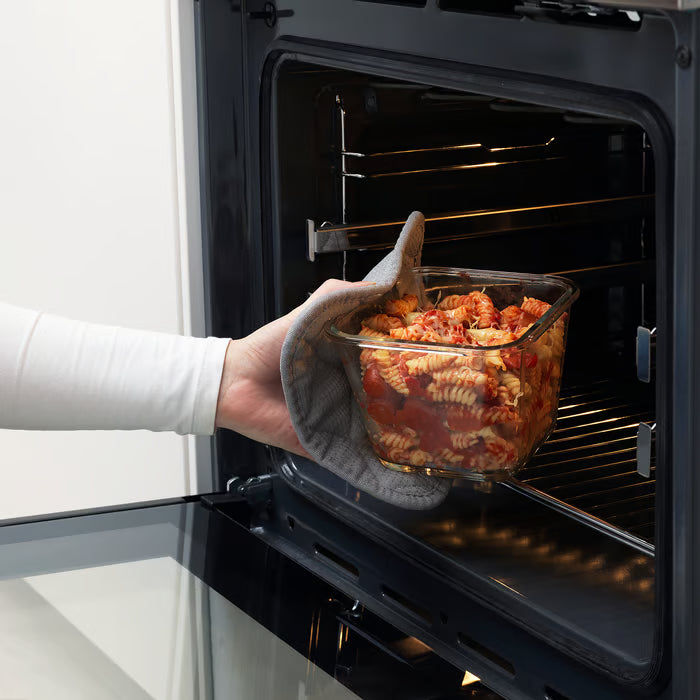 Person placing IKEA 365+ square glass container with pasta into oven demonstrating oven-safe use
