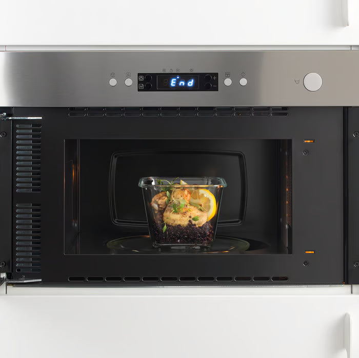 IKEA 365+ square glass food container with cooked food inside a microwave showing microwave-safe feature
