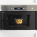 IKEA 365+ square glass food container with cooked food inside a microwave showing microwave-safe feature
