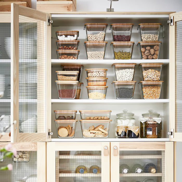 Organised cabinet with IKEA 365+ square glass jars storing grains nuts and dry ingredients stacked neatly