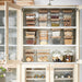 Organised cabinet with IKEA 365+ square glass jars storing grains nuts and dry ingredients stacked neatly
