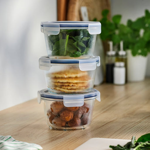 IKEA 365+ glass food containers stacked with varied food inside on wooden kitchen surface