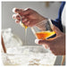 Hand dipping cookie into IKEA 365+ clear glass of milk everyday lifestyle use