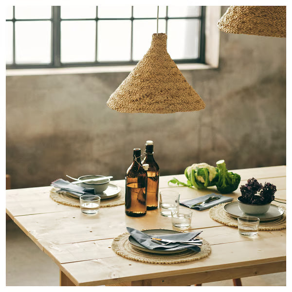 Rustic wooden dining table set with IKEA 365+ clear glasses napkins and fresh vegetables