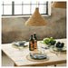 Rustic wooden dining table set with IKEA 365+ clear glasses napkins and fresh vegetables