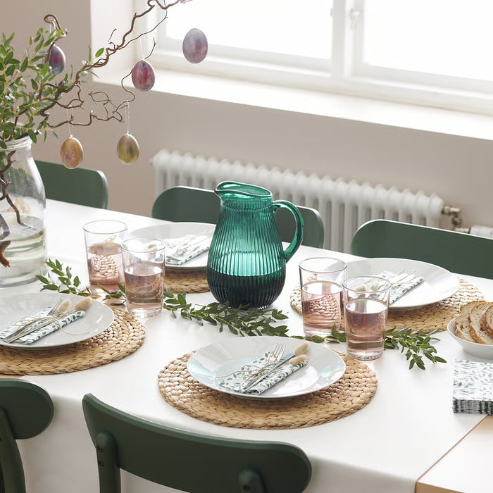 IKEA 365+ clear glasses on dining table with white plates woven placemats and greenery