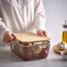IKEA 365+ bamboo lid placed on wire mesh container on kitchen counter near garlic and oil