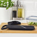 IKEA 365+ black mandoline slicer on wooden cutting board styled in white kitchen with oil dispensers and herbs