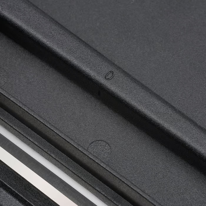 Close-up of IKEA 365+ black mandoline slicer showing smooth blade surface and secure rubber grip edges