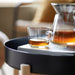 IKEA 365+ glass mug with tea on a tray with papers nearby, lifestyle setting