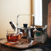 IKEA 365+ glass mug with teapot and tea bag on wooden tray showing brew visibility
