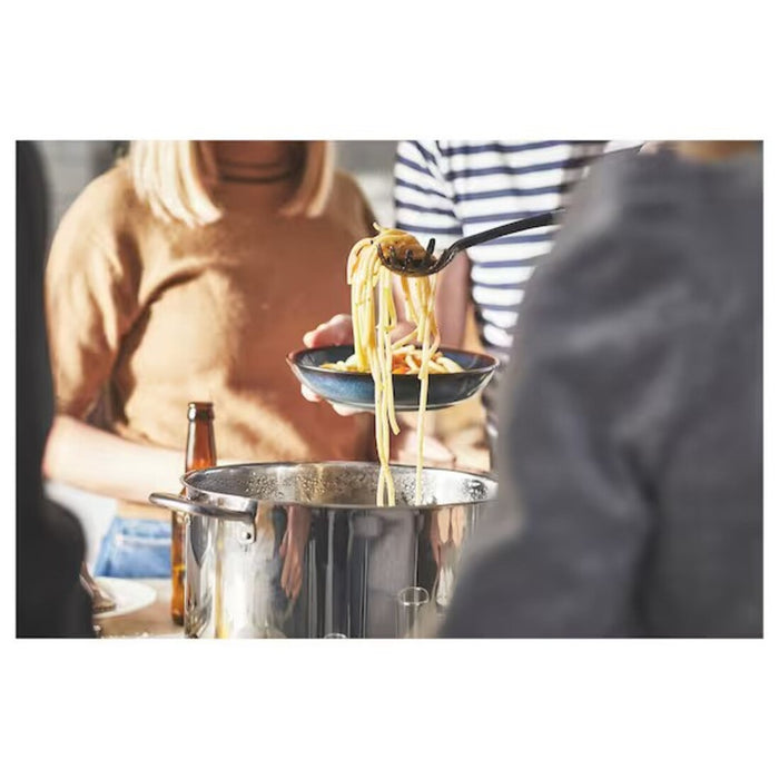 One-pot meal being cooked in the IKEA stockpot with lid, showcasing its large 10L capacity and functional design