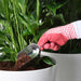 IKEA 365+ metal scoop adding soil to potted plant gardening use