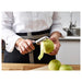 Person peeling an apple with IKEA 365+ VÄRDEFULL black peeler at kitchen counter