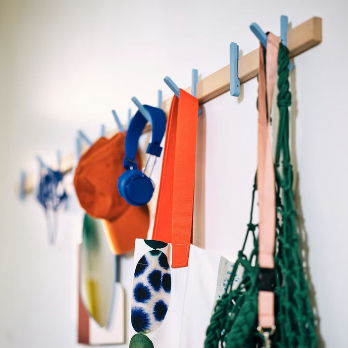 IKEA PS 2026 rack mounted on wall showing hooks in retracted flat position