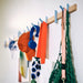 IKEA PS 2026 rack mounted on wall showing hooks in retracted flat position