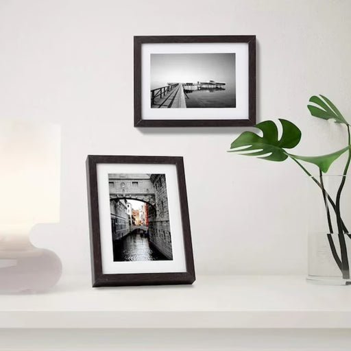  IKEA HOVSTA dark brown frame standing upright on a wooden bookshelf portrait orientation
