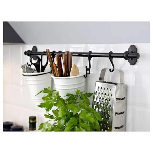 IKEA FINTORP black rail installed on kitchen wall with hooks holding utensils and containers