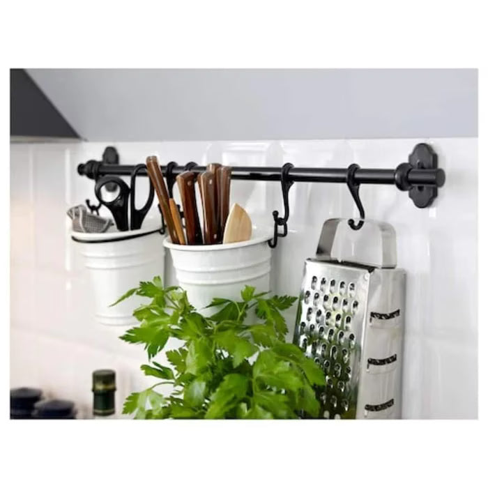 IKEA FINTORP black rail installed on kitchen wall with hooks holding utensils and containers