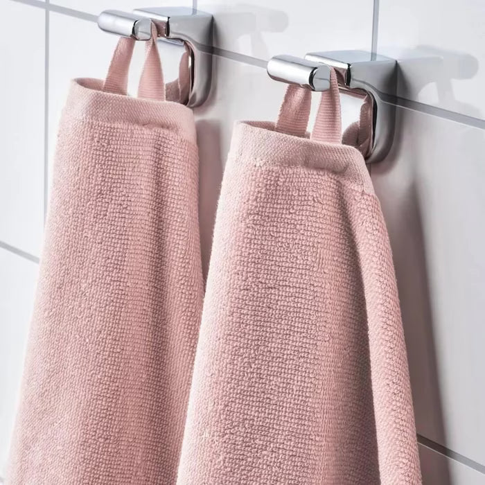  IKEA VÅGSJÖN light pink hand towel hanging on a bathroom rail showing drape and texture

