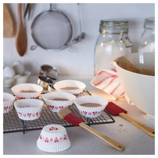IKEA VINTERFINT white heart pattern baking cups filled with cupcakes on a baking tray