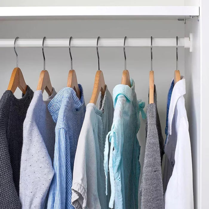 IKEA MULIG white clothes rail in a laundry room holding hangers with clothes airing