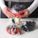 IKEA BEVARA sealing clip in use on a rolled‑up bag of potato chips in a kitchen pantry