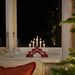 IKEA STRÅLA LED 5-armed candelabra red lit up in cosy home setting showing warm light ambience