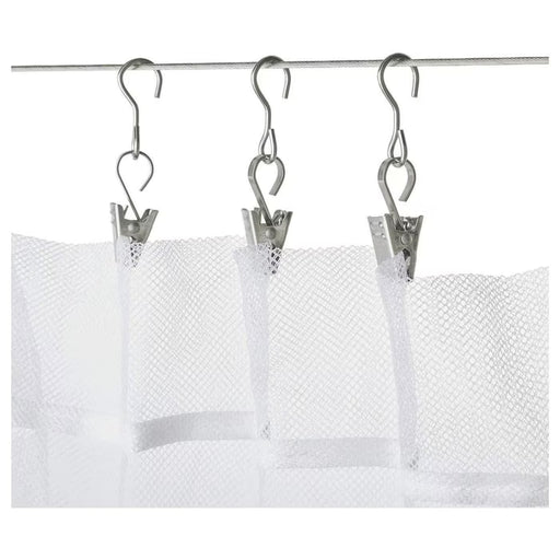 IKEA RIKTIG curtain hook with clip attached to a white curtain on a wire system