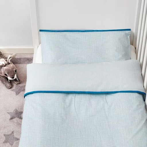 IKEA KLÄMMIG turquoise cot quilt cover laid out on white background showing full size
