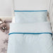 IKEA KLÄMMIG turquoise cot quilt cover laid out on white background showing full size