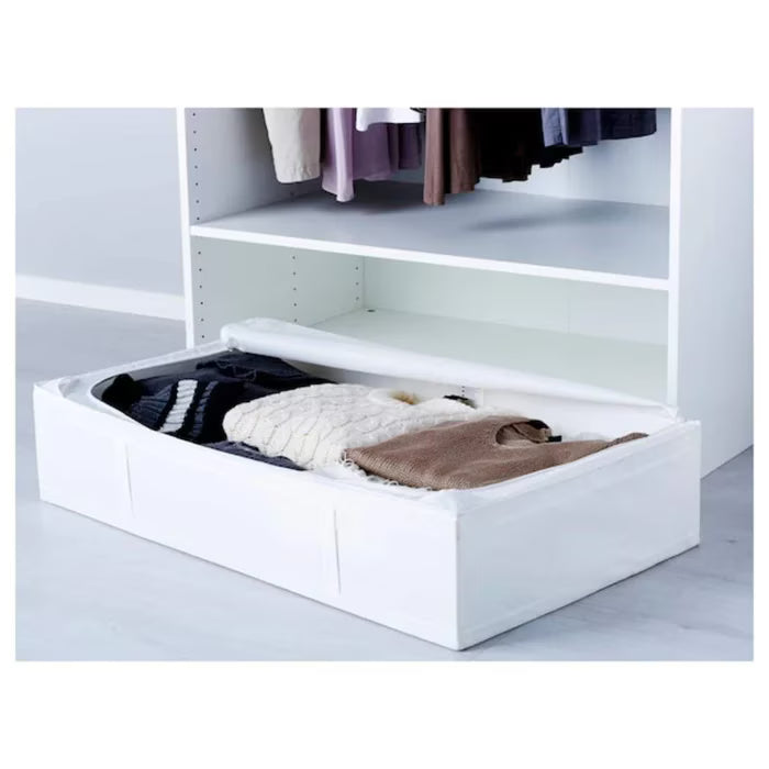 IKEA SKUBB white storage case placed flat under a bed in a bedroom setting
