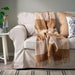 IKEA MYRULL wool throw light brown laid flat on bed showing full 130x170 cm size
