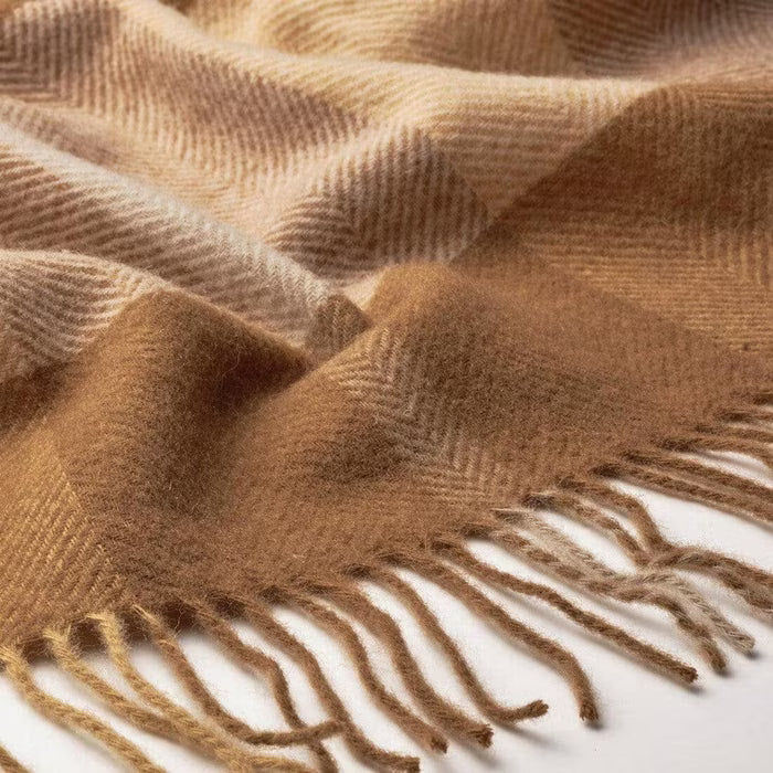 Close-up of IKEA MYRULL light brown wool throw showing brushed texture and check weave detail