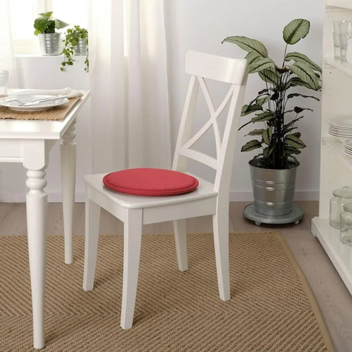 IKEA SUNNEA red chair pad placed on wooden stool showing flexible round fit