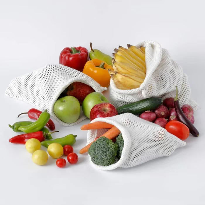 IKEA SKYNKE beige foldable bag being tucked into its small integrated storage pocket