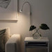 IKEA NÄVLINGE white clamp spotlight mounted as wall lamp in room setting